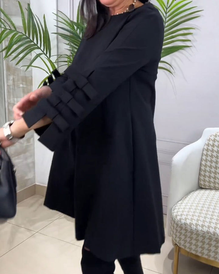 Sort damekjole med lange ærmer og sløjfer